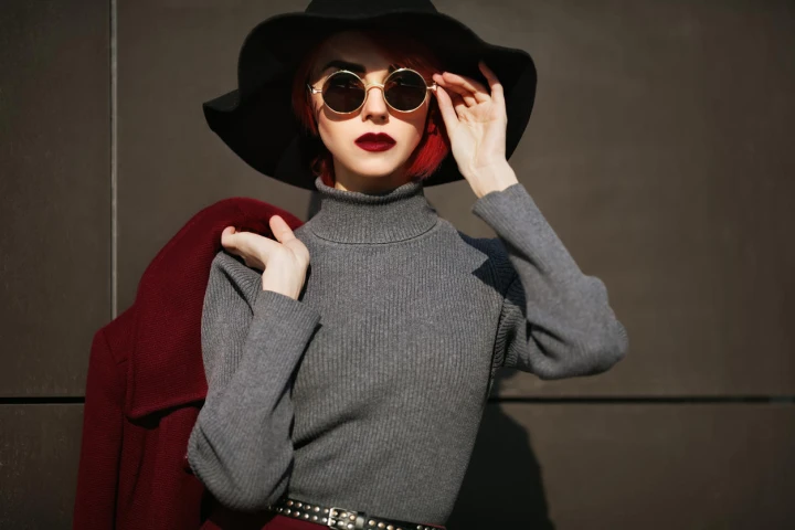 Frau mit Sonnenbrille trägt grauen Pullover mit Turtleneck
